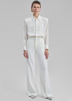 Color: Ivory Midweight woven fabric Regular fit Slightly flared leg Side seam pockets Back welt pockets Belt loops Zip fly Hook and bar closure Unlined 95% Polyester 5% Elastane Hand Wash in Cold Water By The Frankie Shop Classic White Flare Bottoms, Chic Cream Pants With Straight Hem, White Flared Formal Bottoms, White Office Bottoms With Welt Pockets, Tailored White Pants With Pressed Crease, White Bottoms With Welt Pockets For Office, Tailored Cream Wide Leg Pants For Formal Occasions, Formal Cream Pants With Straight Hem, Elegant Tailored White Wide Leg Pants