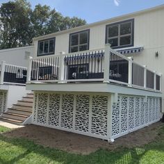 a large white house with two balconies on the front and second story deck