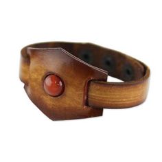 A bright and glossy carnelian stone sits boldly at the center of this rich leather bracelet. Thai artisan Chaloemphon hand-crafts the bracelet finishing it with three brass snap closures. Vintage Leather Bracelet Wristband, Vintage Leather Wristband Bracelet, Vintage Carnelian Bracelets As Gift, Vintage Carnelian Bracelets Gift, Vintage Carnelian Bracelet Gift, Handmade Red Leather Bracelet, Adjustable Red Bracelet With Leather Strap, Brown Jewelry With Waxed Finish As Gift, Adjustable Red Leather Strap Bracelet