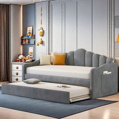 a living room with a couch, ottoman and bed in the middle is decorated in gray tones