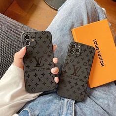 two louis vuitton phone cases sitting next to each other on a person's lap