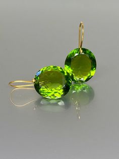 Gorgeous sparkly peridot drop earrings. The Faceted oval drops are flawless and eye clean, The ultra-fine oval drops have a beautiful deep green color. The drops are attached to 24K Gold Vermeil/ 14K SOLID GOLD ear wires. The earrings are elegant, make a statement, and have a lux look. A truly gorgeous pair of earrings. When 14K SOLID GOLD ear wires are being used, the ear wire ends are hand stamped as proof of being 14K solid gold. In addition, extra work was done at the end of the ear wires to Chanel Stud Earrings, Red Garnet Earrings, Ruby Earrings Studs, Extra Work, Peridot Crystal, Peridot Jewelry, Peridot Earrings, Birthstone Earrings, August Birthstone