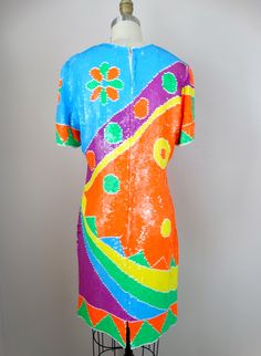 "This is an absolutely STUNNING bright vintage piece fully embellished with sequins! It's in excellent condition! Bust - 36\" Waist - 32\" Hips - 38\" Length - 37\" Tag Size - L (fits like a medium) All of my items come from a pet-free and smoke-free home. If you would like more info or have any questions, please don't hesitate to ask!" Multicolor Festival Dress For Party Season, Multicolor Dress For Festival And Party, Multicolor Dresses For Festival And Party Season, 1970s Style Multicolor Party Dresses, Vintage Dresses For Carnival Party, Vintage Carnival Party Dresses, Vintage Party Dresses For Carnival, Vintage Fitted Sequin Dress For Summer, Vintage Multicolor Costume Party Dress