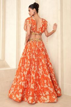 Orange attached cancan lehenga with floral print and a floral applique work waistline. Paired with a floral print blouse with an applique work hem and drawstring details on the shoulder and padded bustier. - Aza Fashions Floral Print Sets For Reception And Festivals, Festive Fitted Floral Print Lehenga, Fitted Floral Print Lehenga For Festivals, Festive Orange Floral Print Sets, Floral Print Organza Lehenga, Floral Print Yellow Lehenga, Peach Floral Lehenga, Lehenga Pattern, Floral Print Blouses