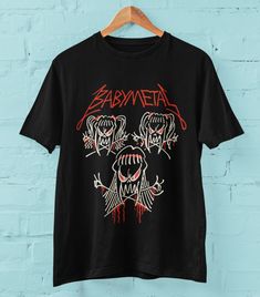 Babymetal Crewneck T-shirt will be a perfect gift for anyone (and for YOU!) who loves Baby Metal!  Get this custom-print awesome artwork from the sensational Japanese kawaii metal band on a Crewneck Tee Shirt! - Our great t-shirt is made of 100% Cotton jersey (Airlume combed and ringspan) - Bella+Canvas 3001 - High Quality - Soft cotton and quality print - High-quality and Lightweight - Retail fit (Unisex), Runs true to size - This graphic is printed on top quality cotton t-shirt using high performance Direct to Garment (DTG) printing technology to ensure a long lasting image. SHIPPING We aim to process all orders as fast as possible and ship them within 2-5 days. However, during sales or busy periods please allow up to 10 days for processing. All orders are shipped from the US (Florida & Babymetal Shirt, Babymetal Merch, Kawaii Music, Kawaii Metal, Awesome Artwork, Metal Shirts, Baby Metal, Metal T Shirts, Japanese Kawaii