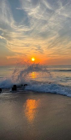 the sun is setting over the ocean waves