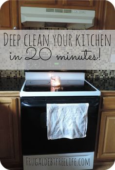 a kitchen stove with a tea towel hanging on it's burner and the words deep clean your kitchen in 20 minutes