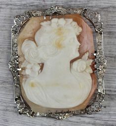 @EstateJewelryStoreART DECO 14 K White Gold Shell Cameo Pendant Brooch Pretty Lady Carved Gorgeous Design N4523FINEST OLD BROOCH / PENDANT. BIG 8 SIDED CAMEO. FLORAL SETTING. GREAT SIZE! AMAZING PENDANT WONDERFUL HIGHEST QUALITY. JUST PART OF MY MOST RECENT ESTATE FINDS! FOLLOW ME TO SEE THEM ALL! Brand: Metal: 14 K White GoldMaterial: Shell CameoForm: Pendant Brooch Pretty Lady CarvedSize :1 3/8" x 1 5/8"Age: ART DECOWeight (Grams): 10.8           ALL ITEMS LISTED AS  GOLD ARE EITHER MARKED AND Carved Brooches For Formal Occasions, Antique Carved Brooches For Formal Occasions, Antique White Brooch For Formal Occasions, Antique White Formal Brooch, Antique Carved Brooches For Weddings, Antique White Gold Collectible Brooches, Vintage White Gold Oval Brooches, Ornate Cameo Brooch For Anniversary, Ornate Cameo Brooches For Anniversary