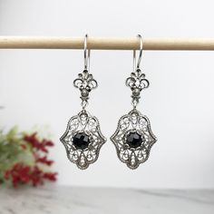 "Handmade Women's 925 Sterling Silver Dangle Drop Earrings with Genuine Black Spinel Gemstones Artisan Crafted Filigree Material: 925 Solid Sterling Silver Genuine Black Spinel Gemstones, 6 mm, Round, Faceted Earrings Length: 2 inches Width: 0.70\" Closure: Ear wire with safety catch Comes with a gift pouch and box Free Domestic Shipping Our handmade designer jewelry is unique in the world with its styling and quality. It is a gift that will create memories for years to come. For this particular Classic Black Filigree Jewelry, Elegant Black Jewelry With Intricate Design, Pierced Antique Silver Drop Earrings, Black Filigree Jewelry For Formal Occasions, Ornate Sterling Silver Gemstone Earrings, Ornate Gemstone Earrings In Sterling Silver, Ornate Black Sterling Silver Jewelry, Ornate Adjustable Nickel-free Jewelry, Victorian Antique Silver Earrings As Gift