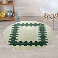 a green and white area rug with an oval design on the floor in front of a chair