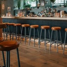 the bar has many stools in front of it