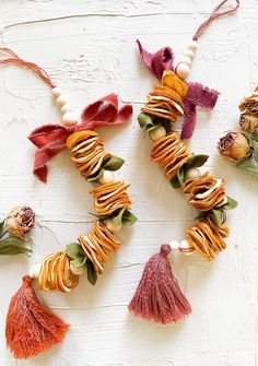 an assortment of tassels are arranged in the shape of a heart on a white background