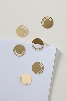 three circles are on top of a sheet of paper with some gold dots around them