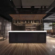 an empty bar in the middle of a room with lots of chairs and tables around it