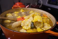 a pot filled with food sitting on top of a stove