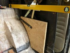 there is a large piece of plywood in the back of a truck with it's door open