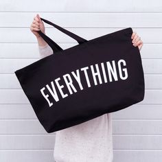 The original, and everyone's favourite, Everything extra large tote. Our large black tote bags are really useful. They make the perfect gym or beach bag and are ideal for weekends away and for your weekly shop. Actually they are pretty handy for everything!Our oversized EVERYTHING bag has been made from thick black canvas, screen printed by hand big and bold in white.Lovingly stitched and printed in the UK. Hooray! Made in the UK 15oz thick black canvas Deep flat base Screen printed in white Mid-length handles 730mm by 440mm by 170mm (28¾ by 17½ by 6¾ inches) Extra Large Tote Bags, Canvas Grocery Bag, Cotton Shopping Bags, Green Tote Bag, Shopping Totes, Cotton Handbag, Green Tote, Sac Week End, Oversized Tote