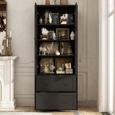 a black bookcase with drawers in front of a fireplace