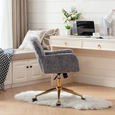 a chair that is sitting in front of a desk with a laptop on top of it