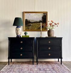 two black dressers sitting next to each other on top of a rug