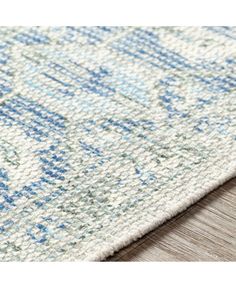 a close up view of a rug with blue and white designs on the carpeting