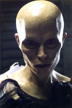 an alien man with white skin and black hair