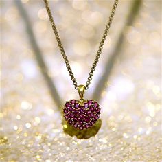 This preloved solid 14k yellow gold and rhodolite garnet heart charm features pave set purplish-pink round, faceted rhodolite garnets in a cute and classic heart shape. The garnets measures 2.5mm in diameter, and there are 26 round faceted garnets in total. The heart charm is suspended by a classic unfixed (moveable) bail. This pendant will be mailed with a vintage gold-filled 2mm rolo chain. This chain measures 20" in length, and can be easily removed from the chain (one side of the chain and c Fine Ruby Heart-shaped Jewelry, Fine Ruby Heart Jewelry, Elegant Heart-shaped Pink Sapphire Jewelry, Valentine's Day Yellow Gold Ruby Jewelry, Valentine's Day Ruby Birthstone Jewelry, Ruby Pendant Jewelry For Valentine's Day, Yellow Gold Jewelry With Lab-created Ruby For Gift, Heart-shaped Pink Sapphire Jewelry As Gift, Heart-shaped Pink Sapphire Jewelry Gift