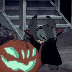 a cartoon character with a pumpkin in front of him and an evil looking cat on the other side