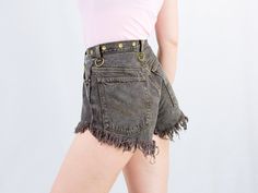 "AUNT GERTRUDE PRESENTS - reworked vintage denim shorts - high waist - golden studs and keyrings - 5 pockets - super frayed - button fly - material: denim and metal keychain SIZE/MEASUREMENTS size from label: no label best fits: M/L waist: 28 inches (71 cm) hips: 41 inches (104 cm) Rise: 12 inches (30 cm) The model is 5'9\" (174 cm), measures 35-27-38 (90-69-96 cm) and wears size M" High Waist Bottoms With Frayed Hem For Festival, Festival Jean Shorts With Frayed Hem, Edgy Cutoff Jean Shorts With Belt Loops, Distressed Cutoff Bottoms For Festival, Distressed Festival Shorts, Festival Distressed Short Bottoms, High Rise Jean Shorts For Festival, Festival Cutoff Jean Shorts With Frayed Hem, 90s High Waist Jean Shorts With Frayed Hem