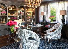 a living room filled with furniture and a chandelier hanging from the ceiling next to a window