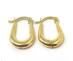 These 14k yellow gold oval hoop earrings are the perfect minimalist accessory. Wearable with anything, yet unique enough to be noticed, these oval hoops are the definition of modern and graceful. At just over under inch in height, these small sized hoops will make a subtle but lasting impression. Their simple yet stylish shape is sure to be in style for years to come. Available in a variety of styles, we are sure to have the unique oval hoops for you! Available in Classic, Twisted, Twisted Diamo Modern Oval 14k Gold Hoop Earrings, Modern 14k Gold Oval Hoop Earrings, Formal Minimalist Oval Huggie Earrings, Formal Hypoallergenic Oval Hoop Earrings, Gold Oval Huggie Earrings, Modern Oval Tarnish Resistant Huggie Earrings, Oval 14k Gold Hypoallergenic Hoop Earrings, Everyday Oval Huggie Earrings With Polished Finish, Yellow Gold Oblong Hoop Earrings For Everyday