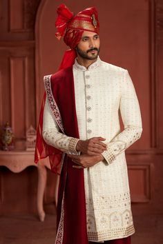 Step into elegance with our exquisite Pure Silk Sherwani, a timeless piece meticulously crafted for the modern man. This Sherwani boasts intricate embroidery, dazzling sequence work, and delicate handwork, adding a regal touch to your ensemble. Available in sizes 32 to 54, this Sherwani is tailored to perfection, ensuring a flawless fit for every gentleman. Elevate your style and make a statement at weddings, receptions, or any special occasion with this luxurious Sherwani. Cream Sherwani, Red Turban, Weddings Receptions, Saree Gown, Cultural Celebration, Sequence Work, Intricate Embroidery, The Cream, White Silk