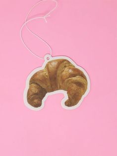 an animal shaped ornament on a pink background