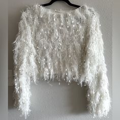 Impressions White Sparkle Stringy Cropped Sweater Size Large Nwt Stay Warm And Stylish For "Fall In Nyc" With This Stunning Ivory Colored Sweater Featuring Lightweight Ultra Fringed Material, A High Rounded Neckline, Long Loose Sleeves With Fitted Cuffs, And A Relaxed Silhouette That Falls Into A Cropped Hemline! Materials Self: 75% Acrylic 15% Nylon 10% Polyester Perfect For Winter Or A Bride Or Some Nye Sparkle! Bachelorette Bridal Sparkle Bachelorette, White Fuzzy Sweater, Sparkle Crop Top, Fall In Nyc, White Sweater Outfit, Sparkle Outfit, Full Sleeve Top, Party Sweaters, Nye Outfits