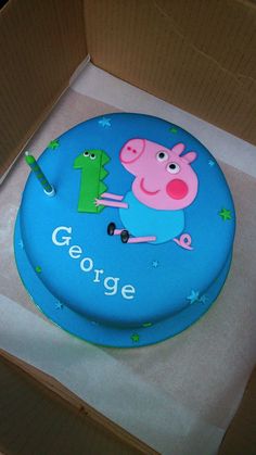 a peppa pig birthday cake in a box with the name george on it's side