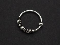 "Nose Hoop, Nose Ring, Hoop Earrings, Ethnic hoops, 22g (0.6mm) Cartilage Silver Small Bali Tribal Bead Hoop Black Piercing Ring 5/16\" (8mm) -------------------------------------------------- Sold individually / Single Piece / 1 Piece. Size: 22 gauge (0.6mm) thick in 5/16\" (8mm) diameter. Made with .925 Sterling Silver Suitable for Cartilage, Upper Ear, Ear Lobe, Helix, Nose Piercing -------------------------------------------------- Shipping Information: Items are shipped worldwide from Thail Hoop Nose Ring, Nose Ring Hoop, Piercing Ring, Nose Rings Hoop, Nose Hoop, Nose Ring Stud, Beaded Hoops, Cartilage Earrings, Body Jewellery