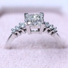 **Our diamonds are 100% REAL, natural earth mined** Unique and delight engagement ring (Or simply a gorgeous ring set with 1-carat princess cut as main diamond and an additional 6 princess cut for side diamonds. Truly unique ring! so elegant on the finger, looks amazing with every outfit :) Setting -Total Carat Weight: 1.20 carat -14K White Gold -Certificate Of Authenticity Included by www.gil-lab.com Main Diamonds: -Princess cut -1 Carat -Color: F -Clarity: SI1 -Clarity Enhanced Side Diamonds: Fine Jewelry Square Cut Diamond Ring, Square Cut Moissanite Rings With Diamond Accents For Weddings, Luxury Square Cut Ring For Promise, Luxury Square Cut Rings For Promises, Diamond White Moissanite Square Cut Ring, Square Cut Diamond Wedding Ring In Diamond White, Radiant Cut Diamond Ring With Vvs Clarity, Timeless Square Cut Moissanite Diamond Ring, Square Cut Moissanite Diamond White Ring