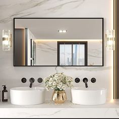 a bathroom with two sinks and a large mirror over it's counter top,