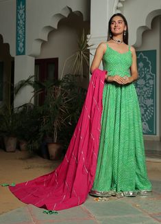 Elevate your summer wardrobe with this beautiful green Anarkali dress, handcrafted from premium quality materials. Perfect for casual occasions, this sustainable outfit features a green Anarkali dress paired with a vibrant pink dupatta. Designed with a modern twist, this Indo western style salwar suit is ready-to-wear and sure to turn heads. Made with care and attention to detail, this Anarkali dress is the perfect gift for the fashion-forward woman in your life. Browse our shop for more unique Lehriya Anarkali, Traditional Outfit For Women, Leheriya Anarkali, Green Anarkali Dress, Green Anarkali, Gown Indian, Pink Dupatta, Wings Dress, Cotton Anarkali