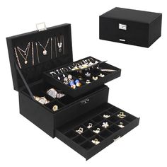 two black jewelry boxes with necklaces and rings in them, one opened to show the contents