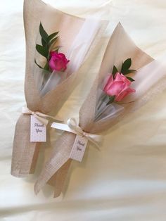 two pink roses tied to burlap bags with thank you tags on the side