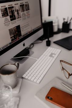 a desktop computer sitting on top of a white desk next to a keyboard and mouse