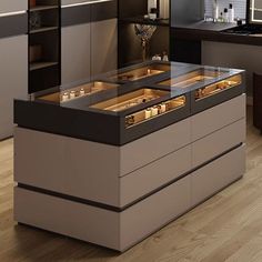 a modern kitchen with an island and countertop that has candles in the drawer on it