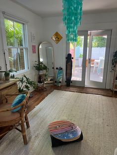 a living room with a rug, table and chairs