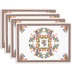 four placemats with an ornate design on the front and sides, each in different colors