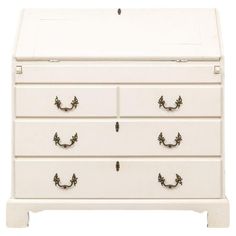 a white dresser with four drawers and two handles