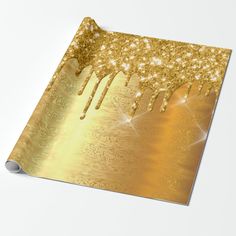 a gold foiled paper with sparkles on it