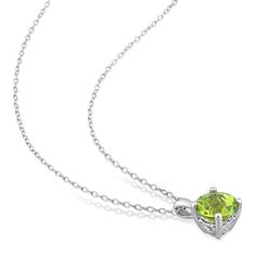 Add a pop of serene color to her attire with this green peridot solitaire pendant and stud earrings set in silver. Crafted in sterling silver Each piece glistens with a 7.0mm round spring-green peridot solitaire - the traditional birthstone for August that is said to bring fame, dignity and protection. Open heart-shaped details along the setting of each earring are a sweet touch. The pendant suspends along an 18.0-inch cable chain that secures with a spring-ring clasp. These post earrings secure Green Peridot Jewelry With Prong Setting, Green Necklace With Prong Setting, Elegant Peridot Jewelry With Prong Setting, Elegant Peridot Round Jewelry, Elegant Round Peridot Stone Jewelry, Peridot Solitaire Jewelry For May Birthstone, Fine Jewelry With Round Cut Peridot, Green Solitaire Jewelry With Round Stone, Formal Lime Green Peridot Jewelry