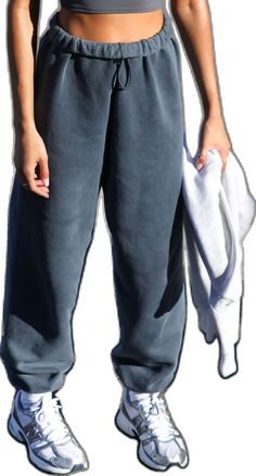 Front view of model from the waist down wearing the oversized loose fit washed navy french terry Oversized Jogger with an elastic waistband and ankle cuffs Relaxed Fit Pull-on Sweatpants For Streetwear, Oversized Cotton Joggers For Fall, Oversized Joggers With Elastic Waistband For Fall, Oversized Drawstring Bottoms For Fall, Oversized Joggers With Elastic Waistband, Oversized Sweats With Elastic Waistband, Baggy Sweats With Elastic Waistband For Loungewear, Baggy Sweats With Elastic Waistband For Leisure, Oversized Comfortable Sweatpants With Elastic Waistband