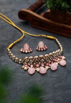 Rose Quartz Kundan and Pearl Choker Necklace Set For Women & Girls Material : Kundan, rose quartz, faux pearl, thread, resin, crystal, glass, and metal Dimension : Necklace - 20 x 3.5 inches approx. Earrings - 1 x 1 inches approx. Rose Quartz, Kundan, and Pearl Choker Necklace Set is a charming piece that will elevate your look to perfection! Dainty stones, in varying sizes and material, are joined together to create this stunning necklace. The finishing touch is given with dangling pearls and r Elegant Pink Round Kundan Necklace, Adjustable Pink Jewelry Set For Party, Pink Kundan Jewelry Sets, Pink Kundan Necklace Gift, Pink Kundan Bridal Necklace For Party, Festive Pink Kundan Necklace For Party, Pink Jewelry Sets For Party And Festivals, Pink Necklaces For Party And Festivals, Pink Jewelry For Party And Festivals